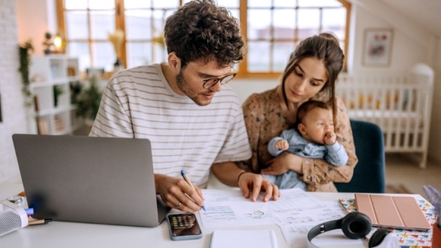 Couple looks at paperwork for buying a home