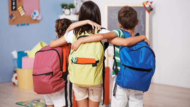 Kids with backpacks in a classroom