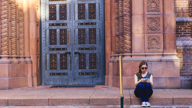 Woman using smartphone at UO library