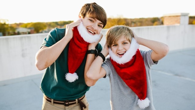 two boys using Santa hats as beards