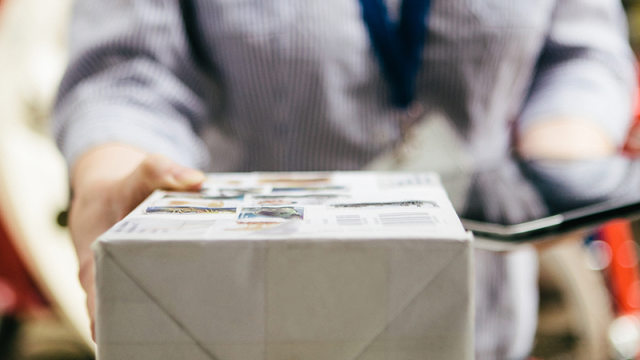 Postal worker delivering package