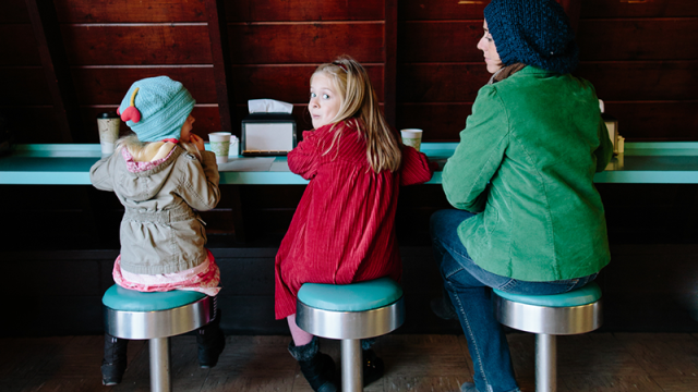 Mom and two daughters in a doughnut shop