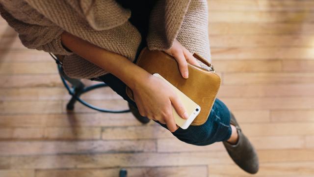 woman holding wallet & smartphone