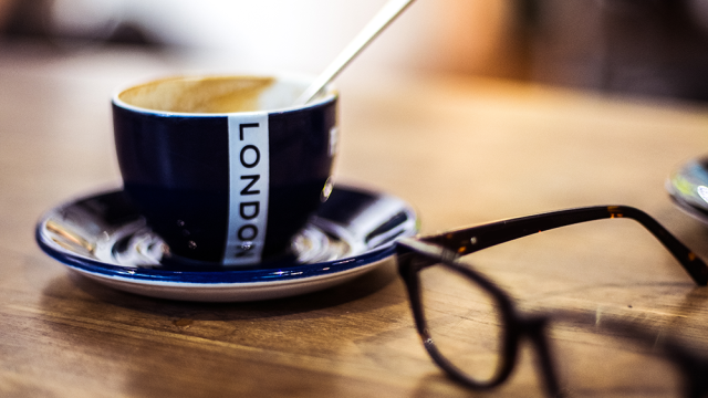 Tea cup that says London with reading glasses