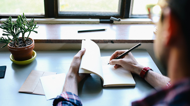 Man writing in notebook
