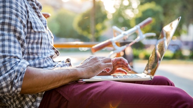 Man outside on laptop