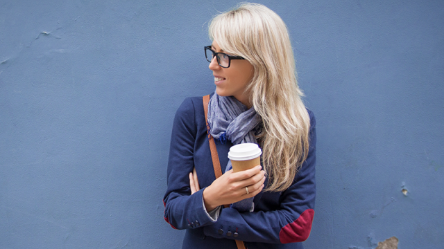 Woman drinking coffee from a to go cup