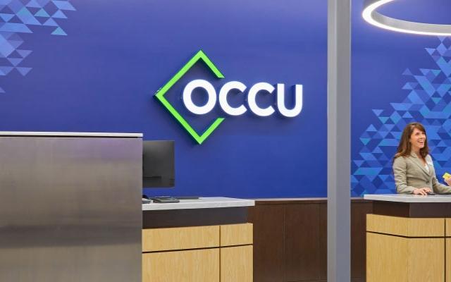 Member working with tellers at the OCCU Royal Branch