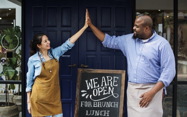 Business owners high fiving